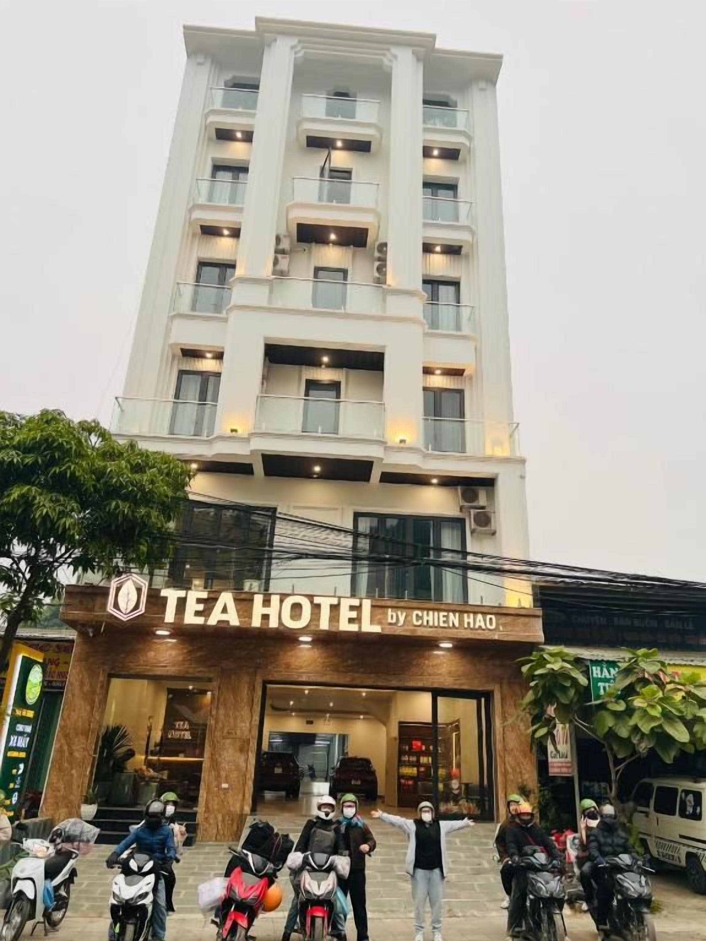 A multi-story building with a sign reading 'TEA HOTEL by CHIEN HAO'.