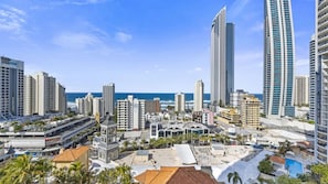A coastal cityscape with high-rise buildings, a marina, and a clear view of the ocean. - Chevron Renaissance Apartment 2146 (Surfers Paradise)