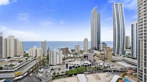 A coastal cityscape with high-rise buildings, a clear sky, and a view of the ocean. - Chevron Renaissance Apartment 2196 (Surfers Paradise)