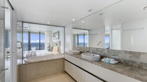 A modern bathroom with a large mirror, two sinks, and a view of the sea through the glass door. - Esplanade Soul Apartment 1605 (Surfers Paradise)