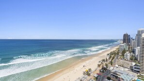 A coastal cityscape with a beach, high-rise buildings, and clear skies. - Esplanade Soul Apartment 2502 (Surfers Paradise)