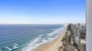 A coastal cityscape with a beach and high-rise buildings. - Esplanade Soul Apartment 5004 (Surfers Paradise)