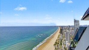 A coastal cityscape with a beach, high-rise buildings, and a clear sky. - Esplanade Soul Apartment 6102 (Surfers Paradise)