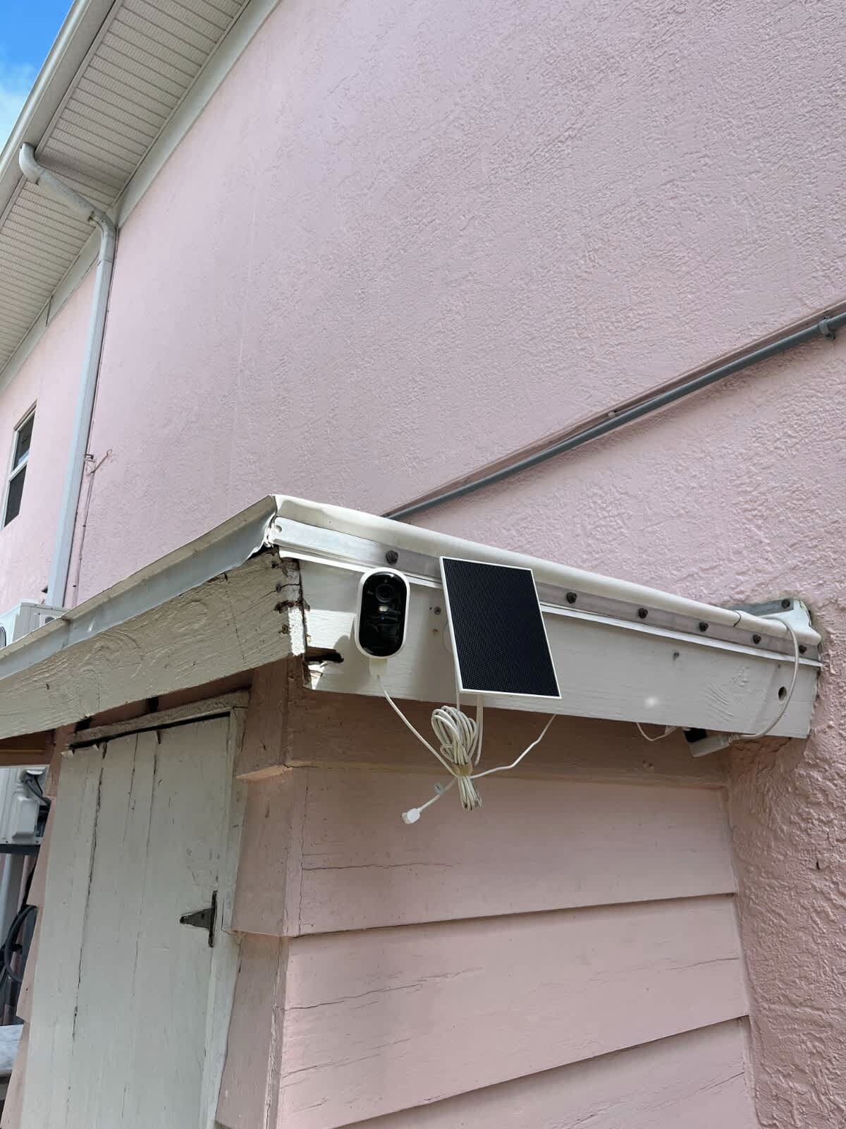 A security camera mounted on a building's exterior wall.