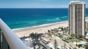 A beachfront hotel with a pool, tennis court, and beach view. - Orchid Residences Apartment 22306 (Surfers Paradise)