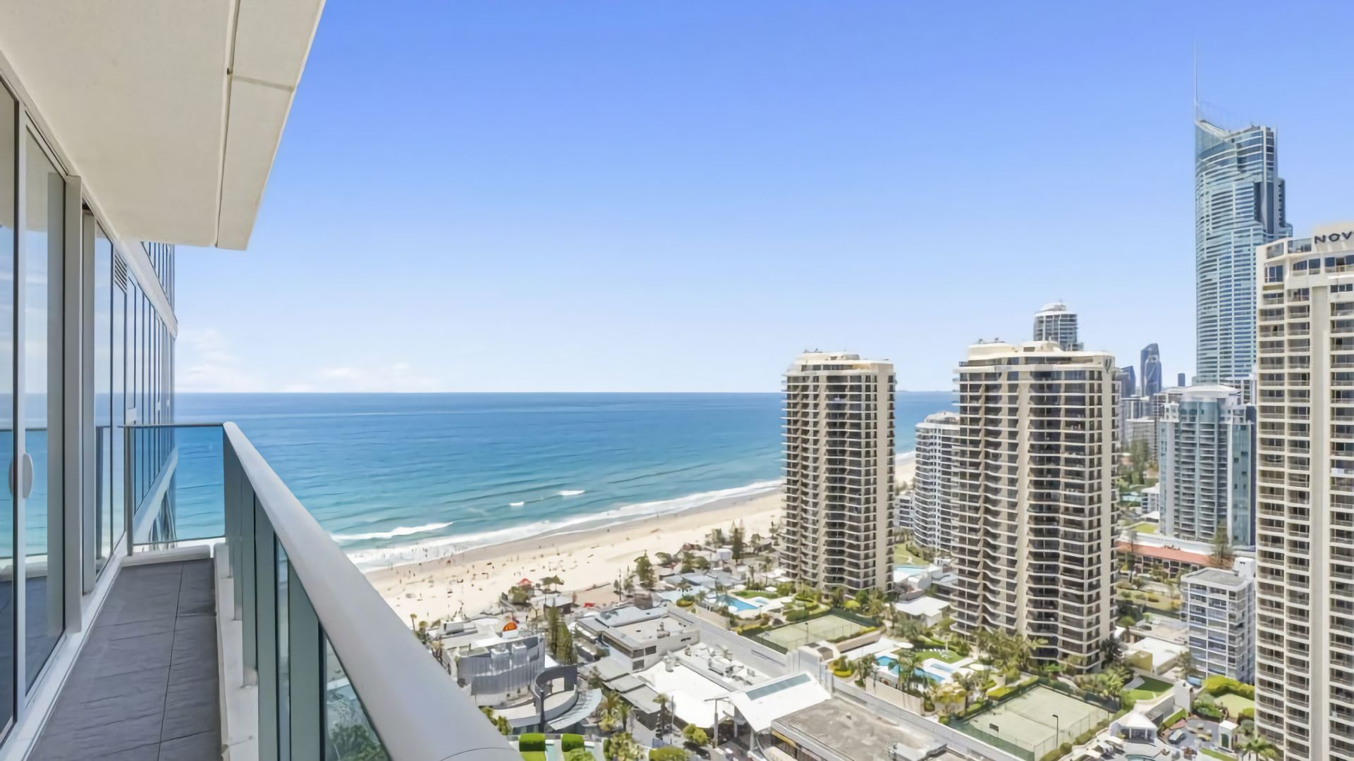 A high-rise building with a view of the beach and ocean.