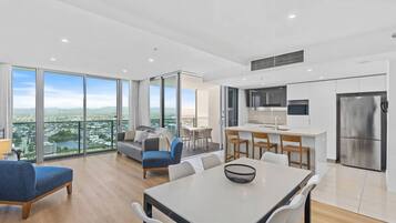 A modern apartment with a balcony, a dining area, and a kitchen.