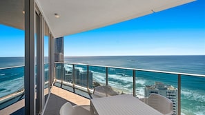 A balcony with a view of the ocean and city skyline. - Orchid Residences Apartment 23403 (Surfers Paradise)