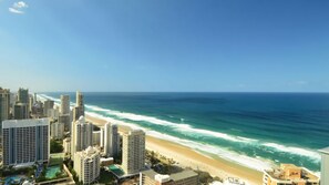 A coastal cityscape with high-rise buildings, a beach, and the ocean. - Orchid Residences Apartment 23701 (Surfers Paradise)