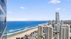 A coastal cityscape with high-rise buildings, a beach, and a clear sky. - Orchid Residences Apartment 23805 (Surfers Paradise)