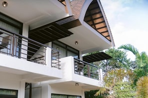 A multi-story building with balconies and a covered outdoor area. - Asian vanda Villa  (Puerto Princesa City)