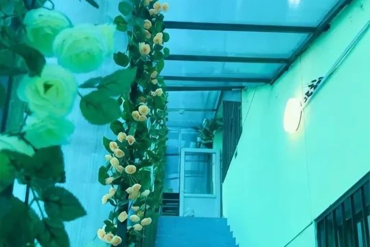 A staircase with a railing, leading to an upper level.