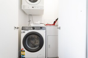 Enjoy the convenience of an in-apartment laundry, complete with a neatly fitted washing machine and dryer to help keep your clothes fresh throughout your stay.