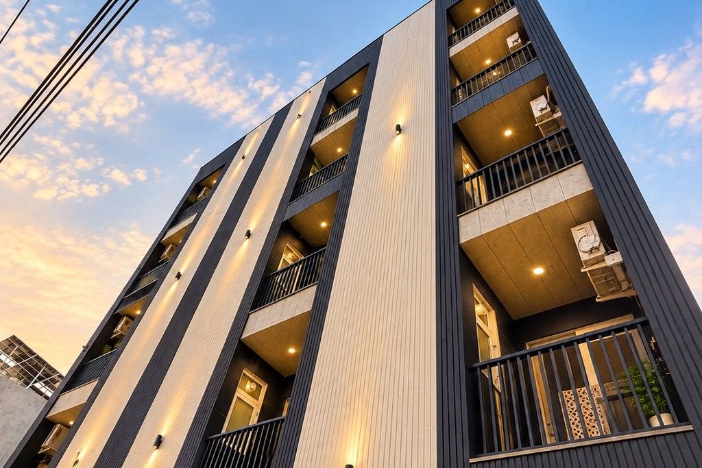 Een meerlaags gebouw met balkons, grote ramen en een modern architectonisch ontwerp.