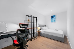 A modern hotel room with a bed, a desk with a mirror, a chair, and a large window. - Sky-High Lv50 Escape| Pool Gym Sauna| Near Skybus (Melbourne)