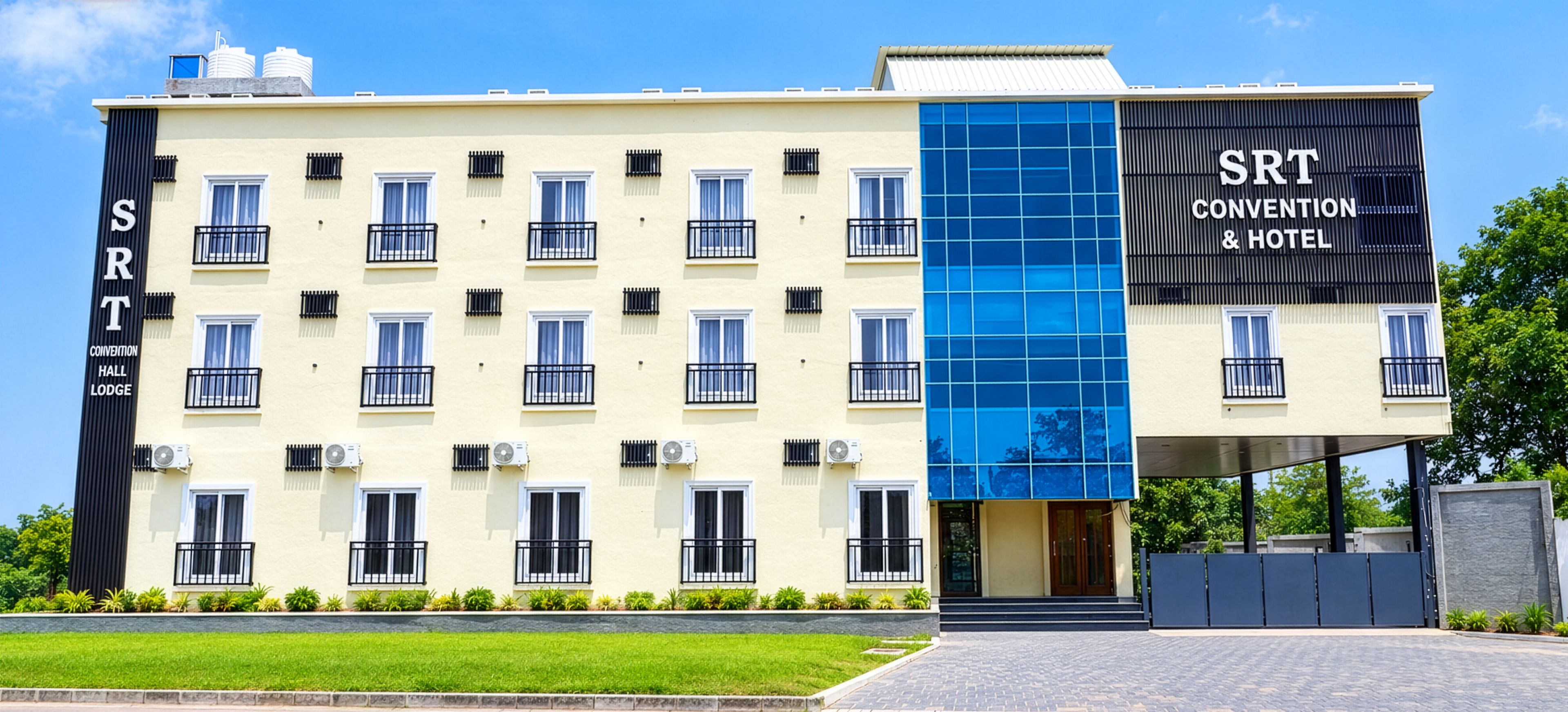A hotel with a modern facade, multiple balconies, and a prominent sign for SRT Convention & Hotel.