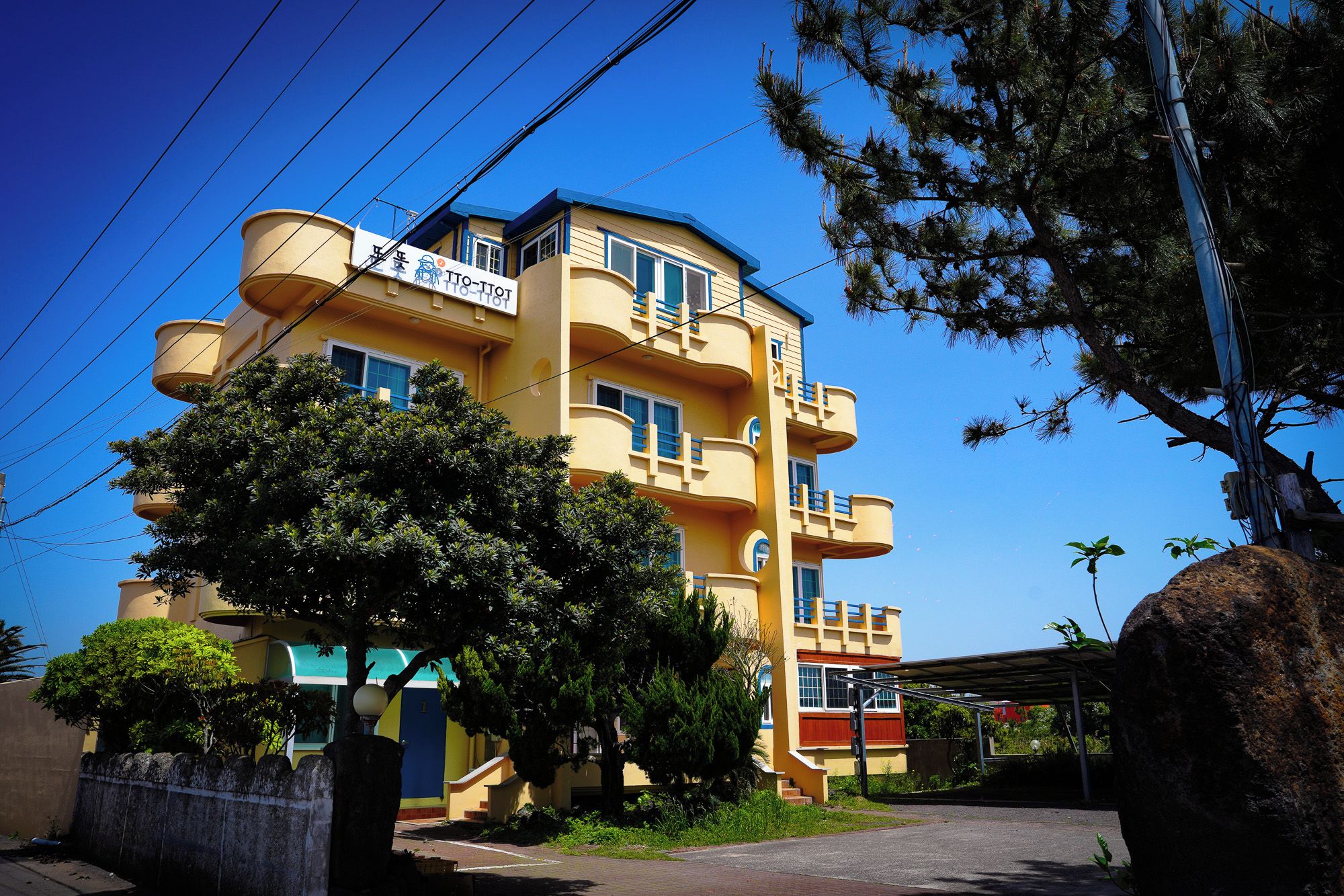 A multi-story building with balconies and a clear sky.