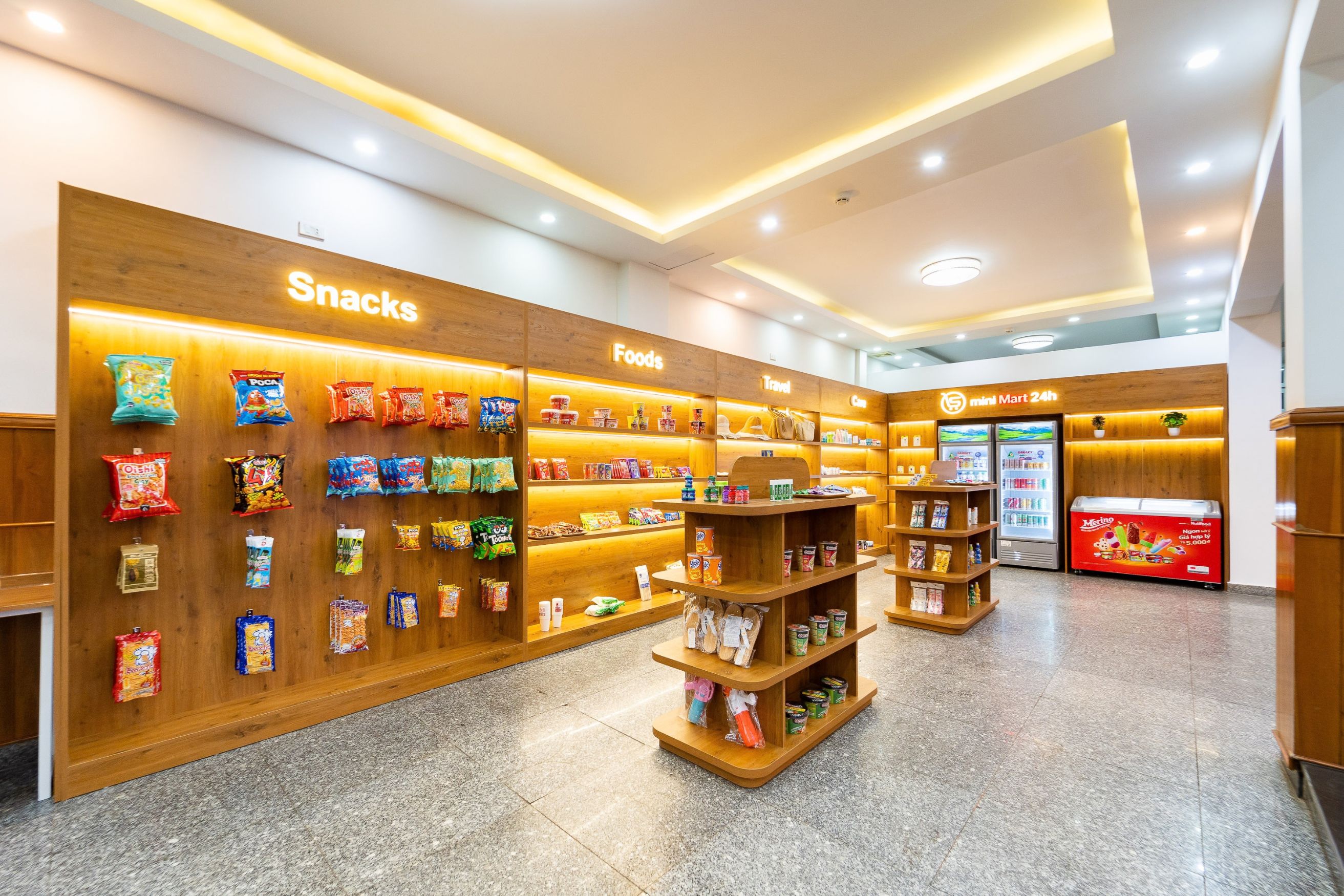 A well-lit snack and food section with various packaged goods on shelves.