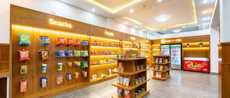 A well-lit snack and food section with various packaged goods on shelves.