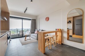 En moderne lejlighed med balkon, køkken, spiseplads og opholdsstue.