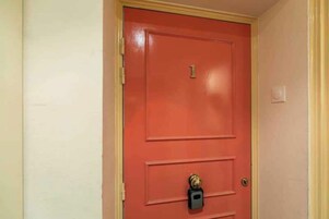 A red door with a number '1' and a keyhole lock.