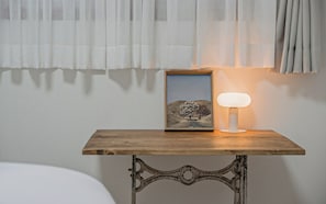 A framed picture on a wooden table with a modern lamp beside it. - Gyeongju Hwangnam Inn Mini Hotel (Gyeongju)
