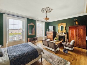 A room with a bed, a desk, a fireplace, and a large mirror. - 4 bedroom accommodation in Montrose (Montrose)