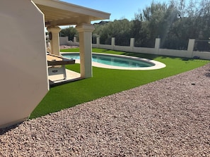 A swimming pool with artificial grass and a pergola. - Charming 3 Bedroom 2 Bath Home in Fountain Hills with Pool and Mountain Views! (Fountain Hills)