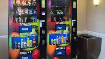 Two vending machines with snacks and drinks, labeled with 'SNACKS' and 'DRINKS' sections, and a 'PUSH' button.