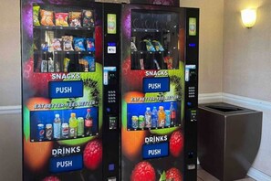 Two vending machines with snacks and drinks, labeled with 'SNACKS' and 'DRINKS' sections, and a 'PUSH' button. - 2 Queen Beds | Non-Smoking (Phoenix)