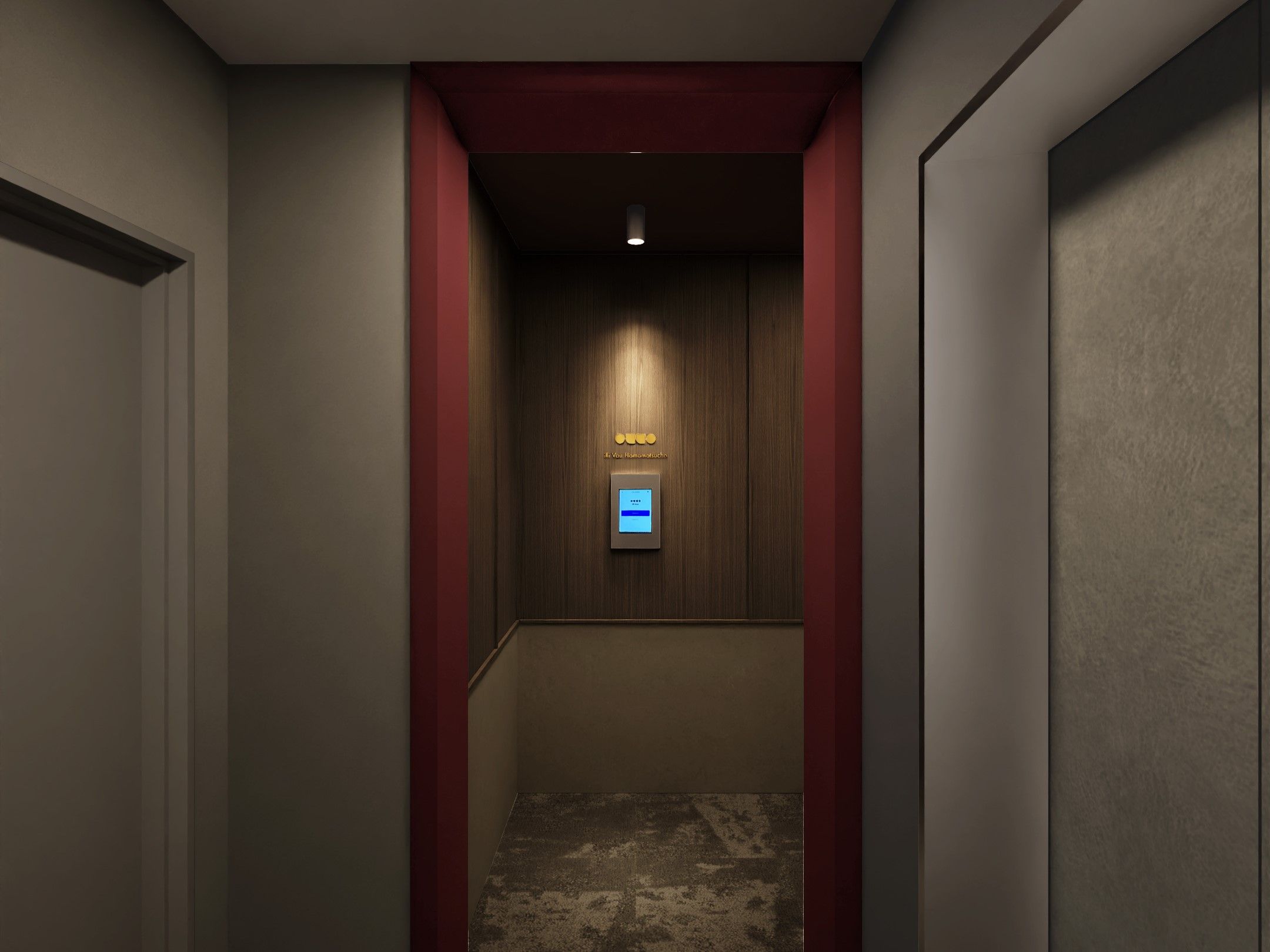 A narrow hallway with a wooden wall and a red accent wall. A digital elevator control panel is visible at the end of the hallway.