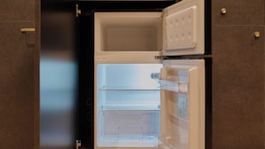 An open refrigerator with two shelves and a freezer compartment. - illi Vau Hamamatsucho (Minato-ku)