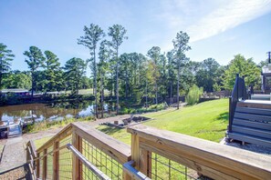 A wooden deck with a view of a lake and trees. - Communal Fire Pit & Dock! Tiny Home By Lake Murray (Gilbert)