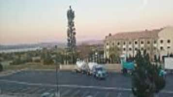 A parking lot with a building in the background.