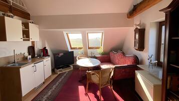 A spacious loft with a kitchen, dining area, and seating space.
