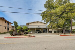 A building with a covered parking area and a sign indicating parking restrictions. - 1 Mi to Beach! Walkable Extended Base in Monterey (Monterey)