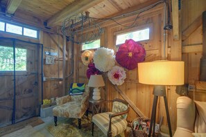 A wooden interior with a shower sign, a water sign, a lamp, and a chair. - Fire Pit, Deck! Rural Retreat Near East Beach (Charlestown)