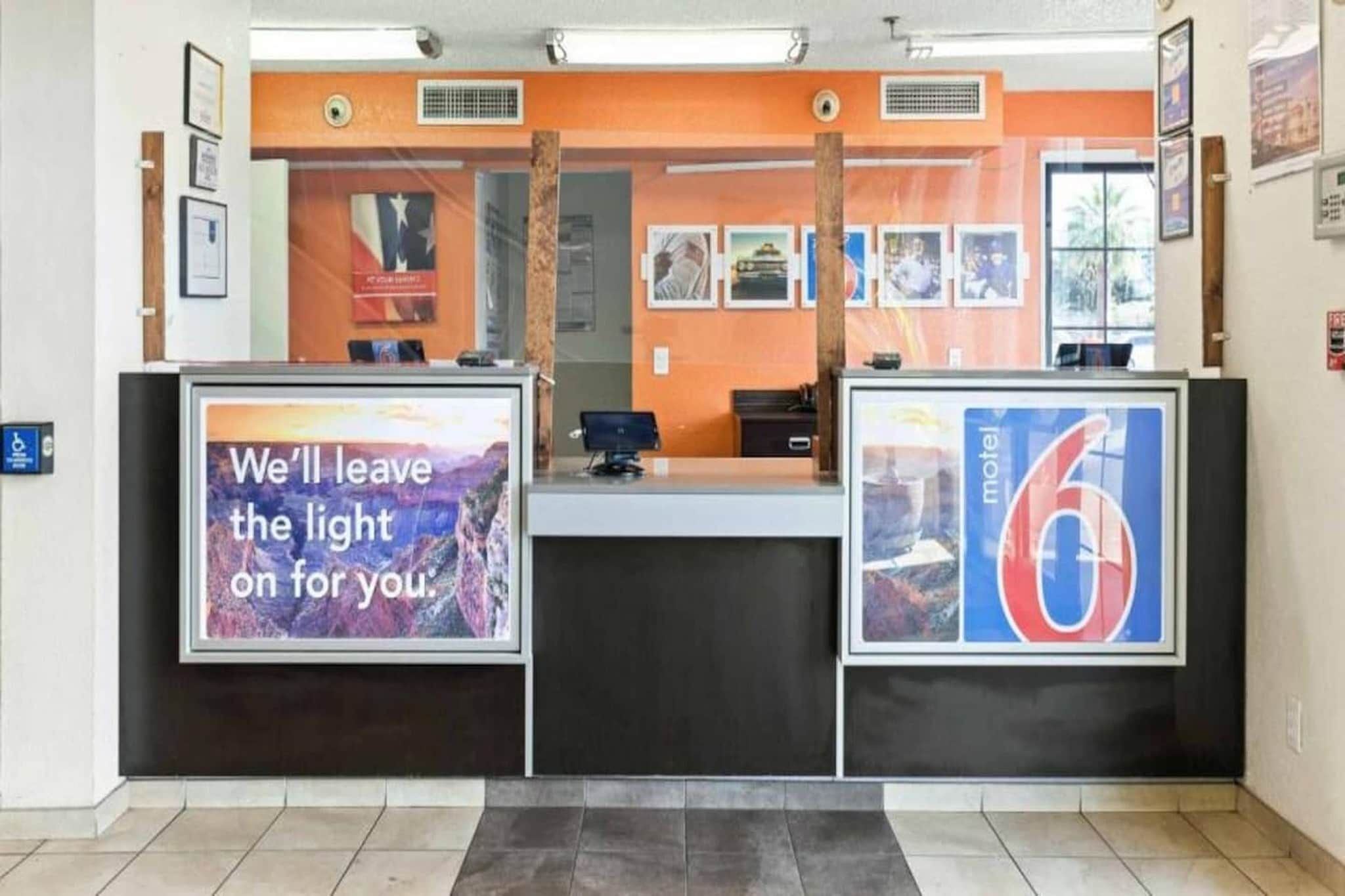 A reception desk with a sign that reads 'We'll leave the light on for you.'