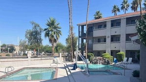 A hotel with a pool area, including two swimming pools and lounge chairs. - 1 King Bed | Non-Smoking, Micfridge (Tempe)