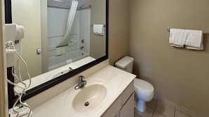 A bathroom with a sink, mirror, toilet, and towel rack. - 1 King Bed | Non-Smoking, Micfridge (Tempe)