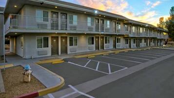 A motel with a parking lot and a fire hydrant.