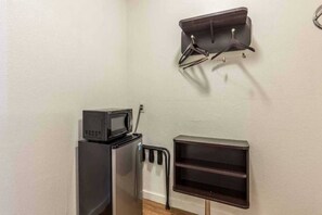 A kitchenette with a microwave, a small refrigerator, and a built-in shelf unit. - 2 Full Beds | Non-Smoking (San Rafael)