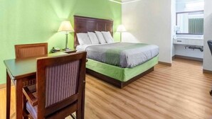 A hotel room with a bed, bedside lamps, a desk, and a chair. - 1 King Bed | Mobility Accessible Tub, Nsmk (Kingsburg)