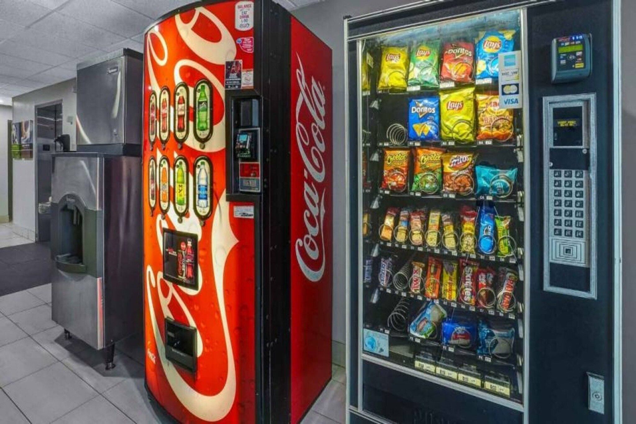 A vending machine with a Coca-Cola logo and a selection of snacks.