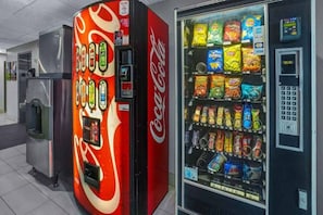 A vending machine with a Coca-Cola logo and a selection of snacks.
