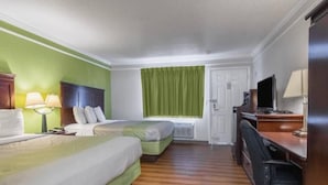 A hotel room with two beds, a desk with a chair, a television, and a window with curtains. - Cozy Studio 1 Queen Bed|Free Wifi (Kingsburg)