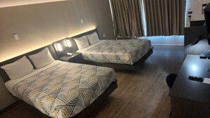 A hotel room with two beds, a desk, and a window with curtains. - 2 Full Beds|NS| Micfridge (Glendale)