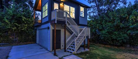 A two-story house with a front entrance, a staircase, and a garage.