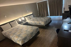 A hotel room with two beds, a desk, and a window with curtains. - 2 Full Beds | Mobil Access Tub Nsmk Micfridg (Glendale)