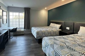 A hotel room with two beds, a desk, and a chair. - 2 Queen Beds|Mobil Access|Micfridg (Buena Park)